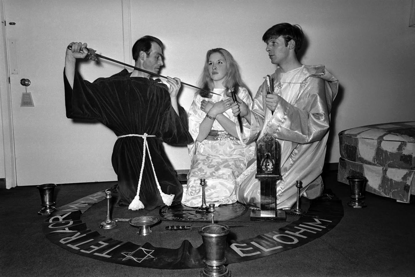 Alex Sanders and members of a coven in ritual dress, gathered for a group portrait.